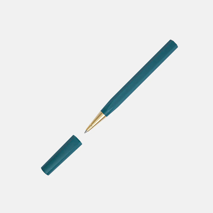 Y Studio Glamour Evolve Ocean sustainable rollerball pen with sleek design and modern branding, displayed on a neutral background.