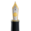 Pelikan Souverän M1000 green fountain pen with gold trim and piston filling mechanism on a white background.