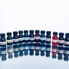 Set of 12 Papier Plume fountain pen ink bottles, each containing 15ml of vibrant ink for writing and calligraphy.
