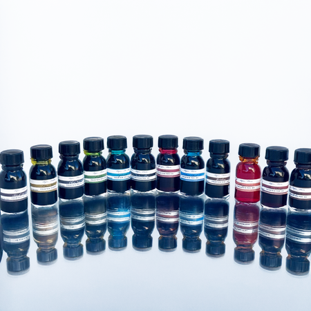 Set of 12 Papier Plume fountain pen ink bottles, each containing 15ml of vibrant ink for writing and calligraphy.