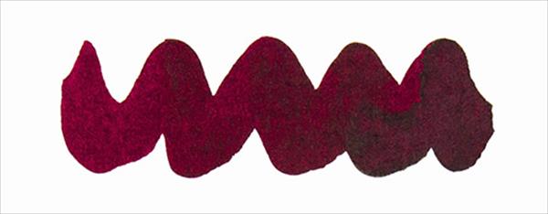 Bottle of Diamine Writers Blood fountain pen ink showing a rich red ink in a clear glass bottle.