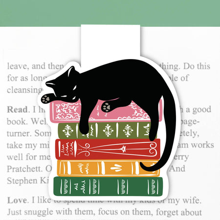 Magnetic cat bookmark from Lucy Loves Paper holding a book open with a cute feline design and colorful magnetic closure.