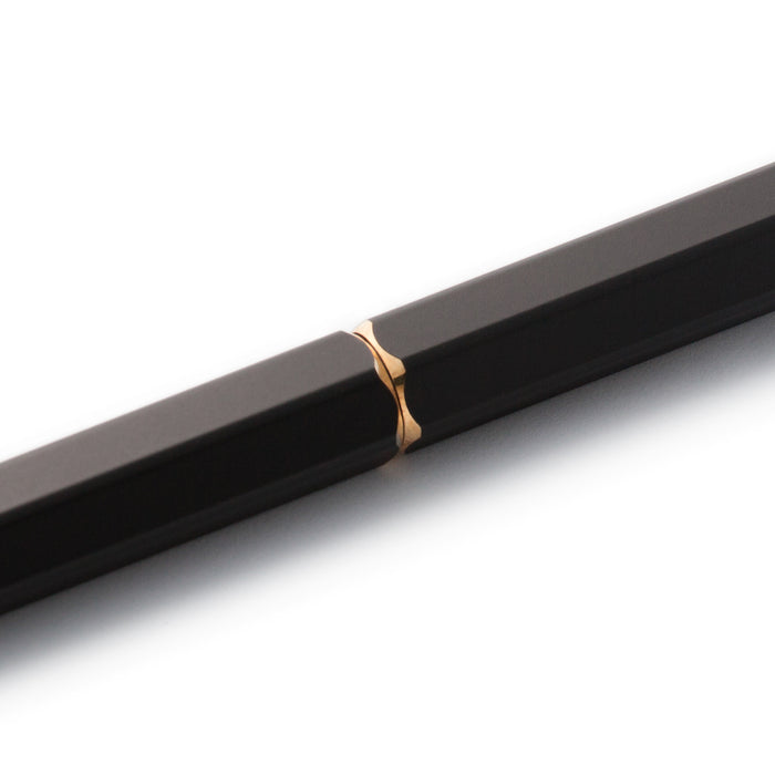 Black Y Studio Brassing portable ballpoint pen with sleek design, shown from the side on a neutral background.