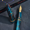 Esterbrook x BUNGUBOX Kingfisher Estie fountain pen with vibrant blue and gold accents on a white background.