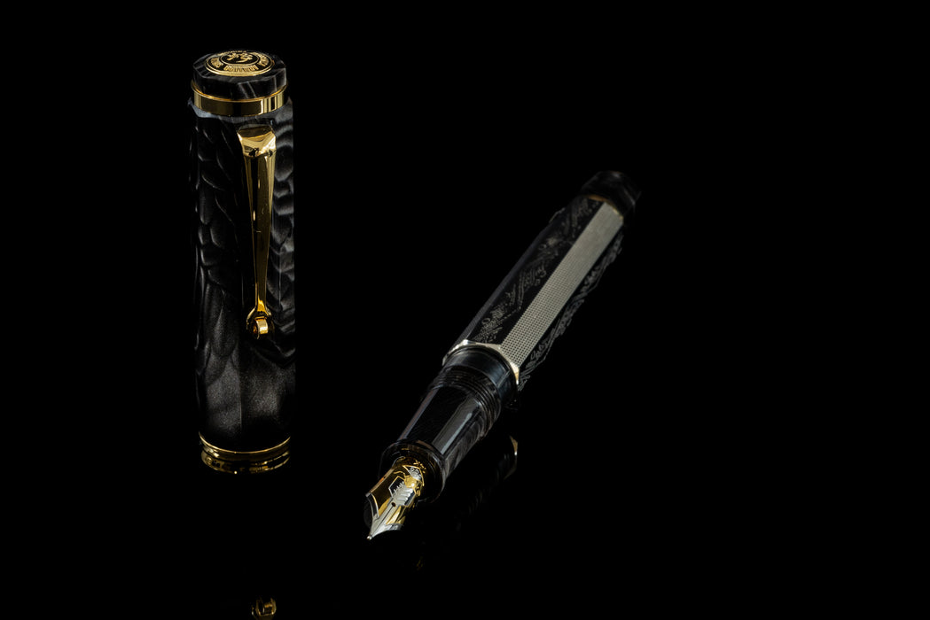 Omas Cobra limited edition fountain pen with sleek black body and gold accents, detailed close-up of the elegant writing instrument.