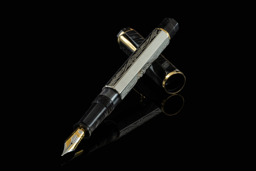 Omas Cobra Limited Edition fountain pen with black and gold design, featuring a sleek, polished body and gold accents.