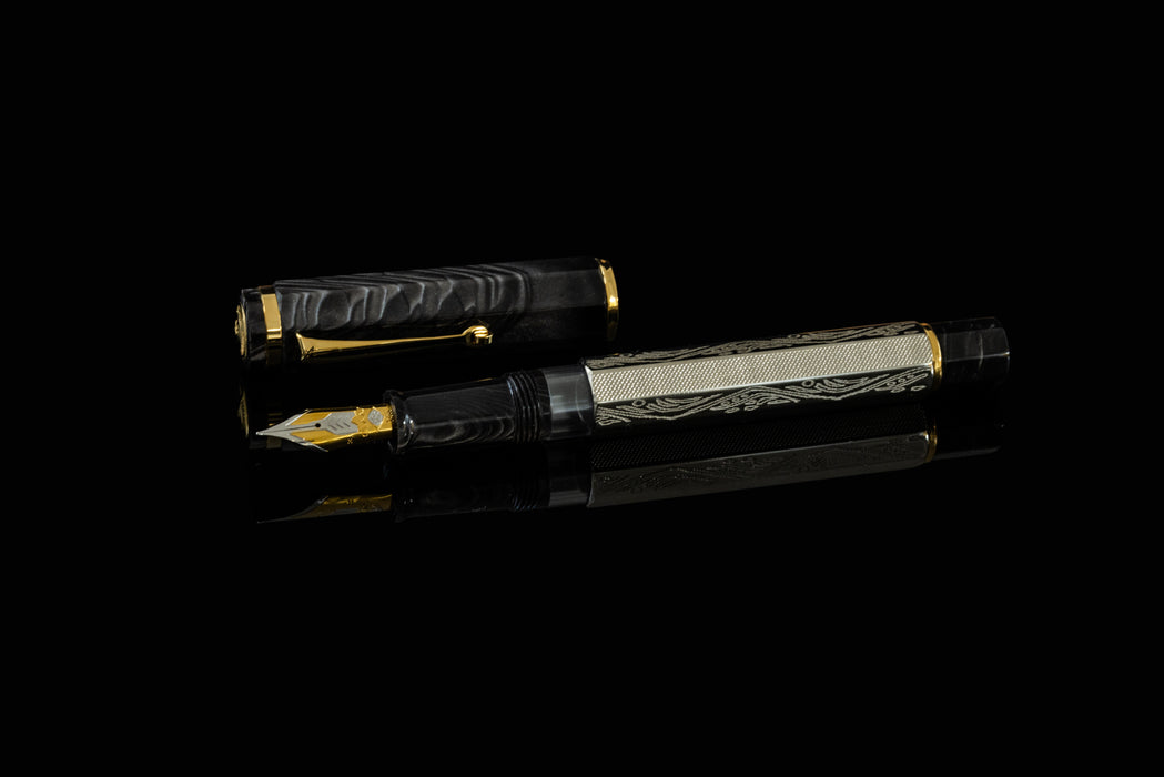 Omas Cobra limited edition fountain pen with black and gold design, showcasing smooth body and elegant nib.