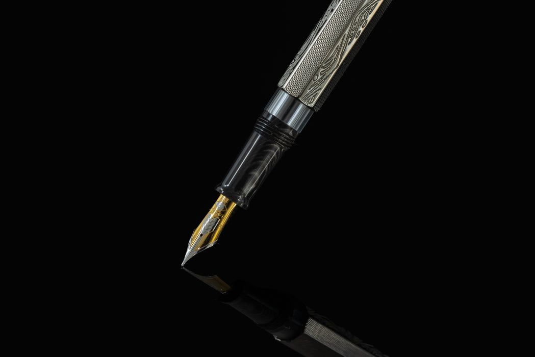 Omas Cobra Limited Edition fountain pen with black body and gold accents, displayed on a white background.
