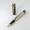 Omas Cobra Limited Edition fountain pen with black body and gold accents, close-up view showcasing elegant design details.