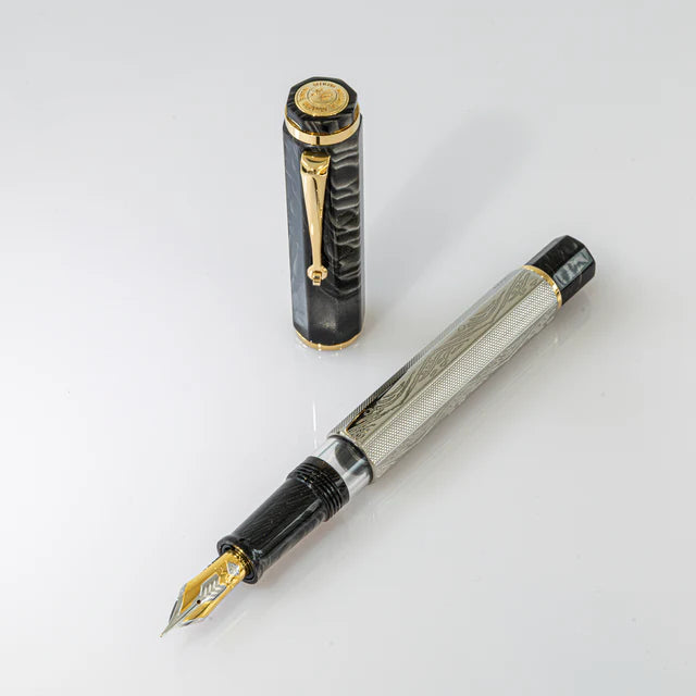 Omas Cobra Limited Edition fountain pen with black body and gold accents, close-up view showcasing elegant design details.