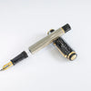 Omas Cobra limited edition fountain pen with sleek black design and gold accents, close-up view of the luxurious writing instrument.