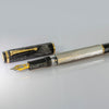 Omas Cobra limited edition fountain pen with sleek black body and gold accents, displayed on a white background.