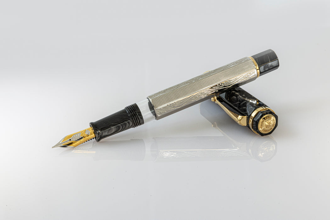 Omas Cobra Limited Edition fountain pen with sleek black design and gold accents, showcasing its elegant craftsmanship.