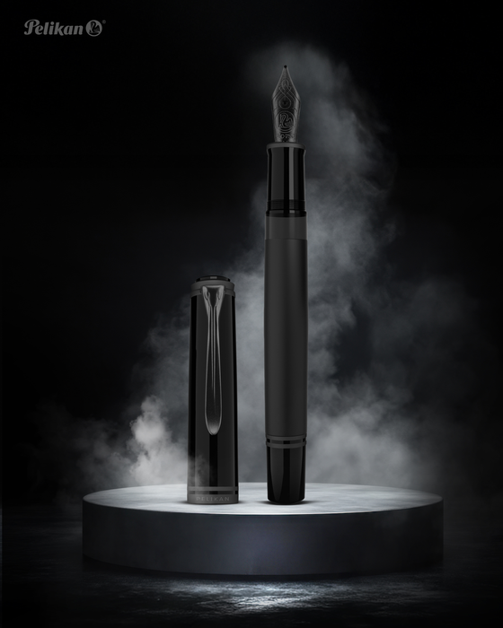 Pelikan Souverän M809 black matte fountain pen with gold accents and a silver clip, close-up of the pen's body and cap.