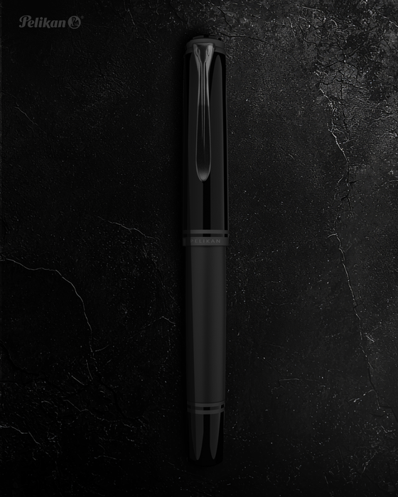 Pelikan Souverän M809 black matte fountain pen with gold accents and textured grip section.