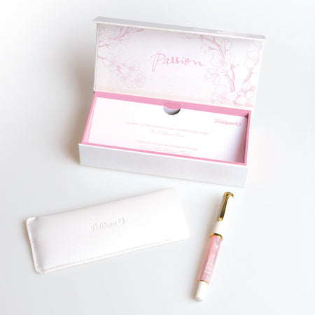 Pelikan M200 Cherry Blossom fountain pen with pink and white marbled design and gold accents on the cap and clip.