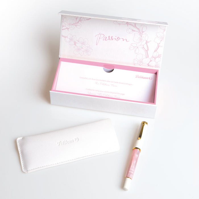 Pelikan M200 Cherry Blossom fountain pen with pink and white marbled design and gold accents on the cap and clip.