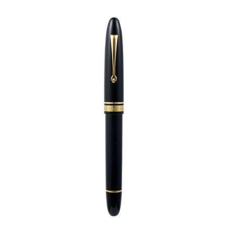 Omas Ogiva Nera fountain pen with black body and gold accents, showcasing its elegant design and smooth writing tip.