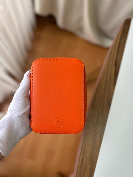 Eng Leather Co. pumpkin-colored leather 4-slot A6 pen case showing four pens inside on a neutral background.