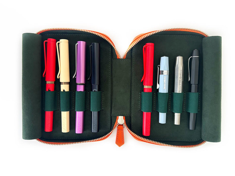 Eng Leather Co. pumpkin leather 4-slot A6 pen case with four pens inside, showcasing a stylish and functional storage solution.
