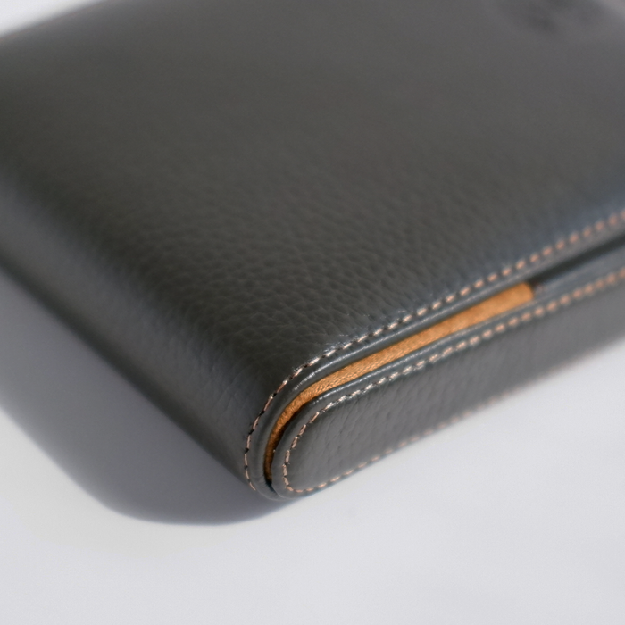 Green leather pen case by Eng Leather Co. holding five pens with a sleek, structured design.