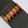Green leather pen case by Eng Leather Co. holding five pens, with a sleek, compact design and sturdy zipper closure.