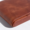 Light brown Eng Leather Co. 5 pen hard case with sturdy exterior and sleek design, ideal for organizing and protecting pens.