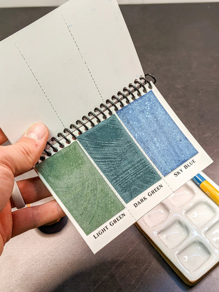 Peerless Watercolors Mini Complete Edition set of watercolor pans with vibrant colors and compact design for painting on the go.