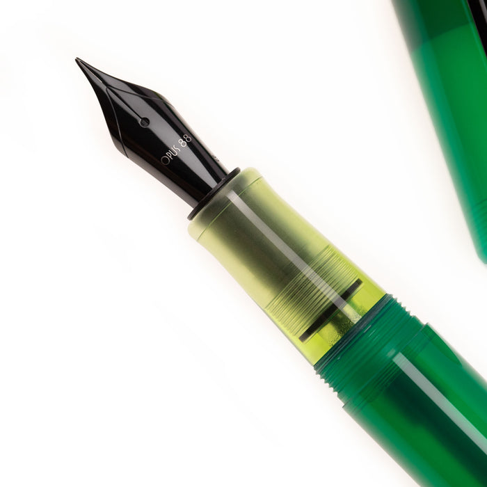 Opus 88 Green Demo fountain pen with transparent green resin body and gold accents.