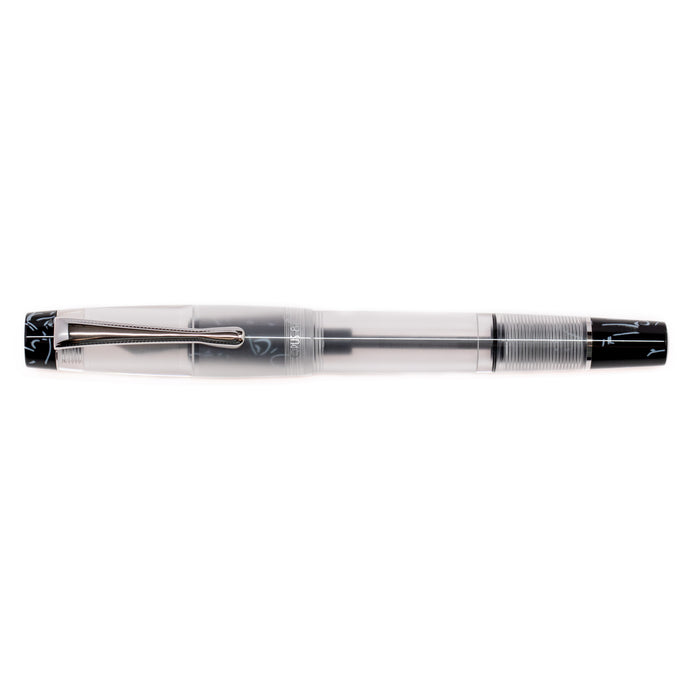 Opus 88 KOLORO black fountain pen with transparent body and gold accents, showcasing the pen's sleek design and nib.