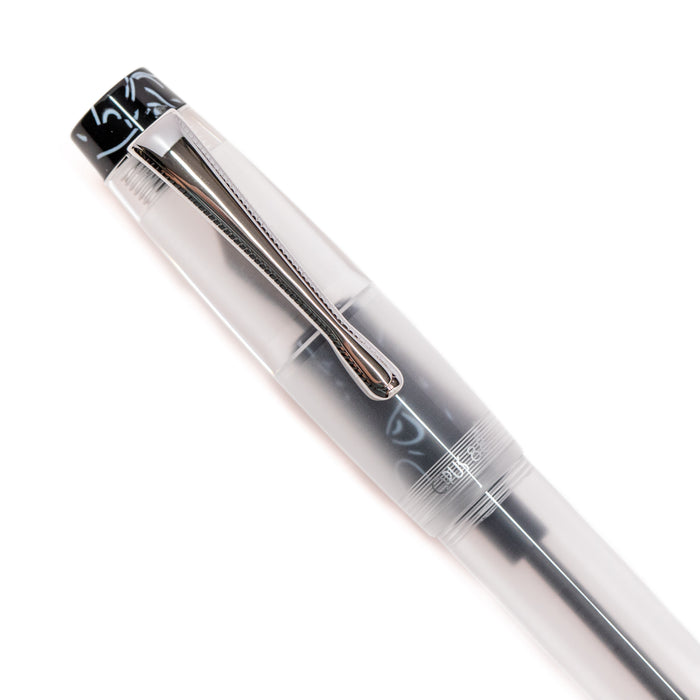 Opus 88 KOLORO black fountain pen with transparent body and gold accents, showcasing its nib and elegant design.