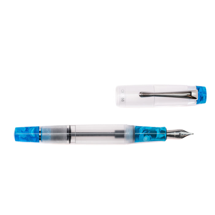 Opus 88 KOLORO fountain pen in light blue with transparent resin body and gold accents, showcasing elegant design and craftsmanship.