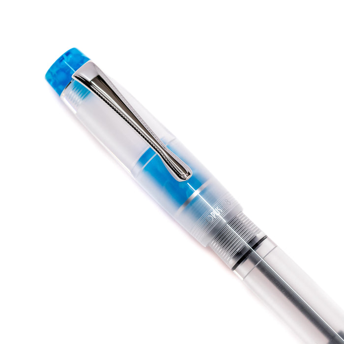 Opus 88 KOLORO light blue fountain pen with transparent body and gold accents, showcasing its elegant design and nib.