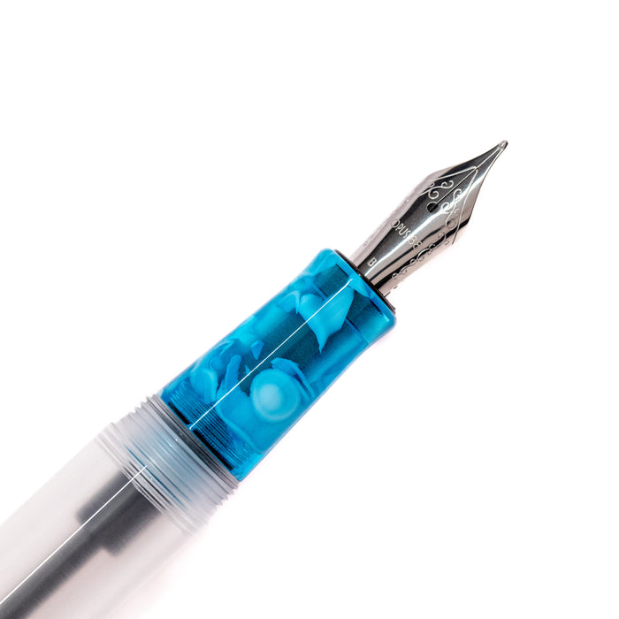 Opus 88 KOLORO Light Blue fountain pen with transparent blue barrel and silver clip, showcasing elegant design and craftsmanship.