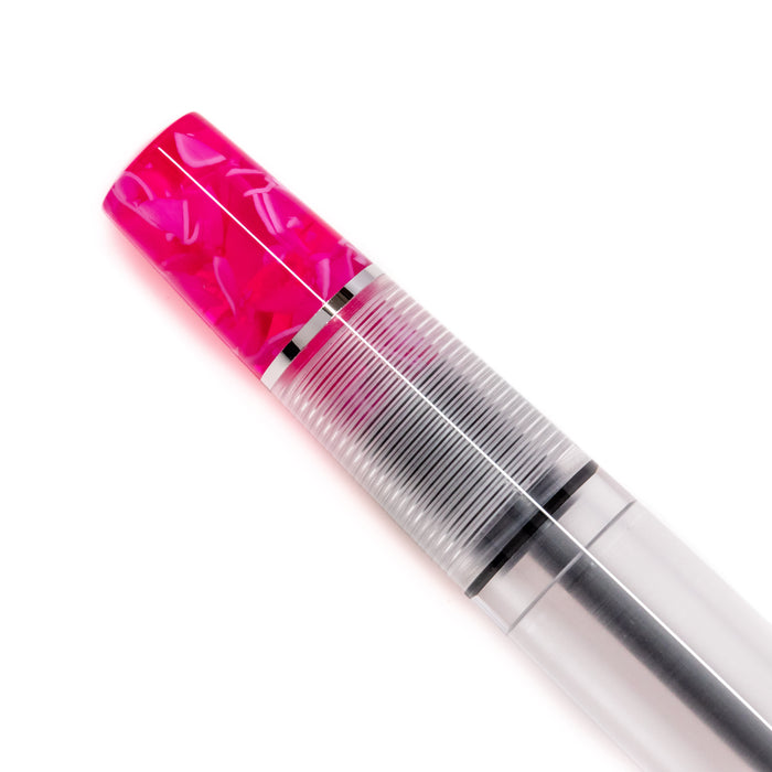 Opus 88 KOLORO hot pink fountain pen with transparent grip section and gold accents, showcasing its vibrant design.