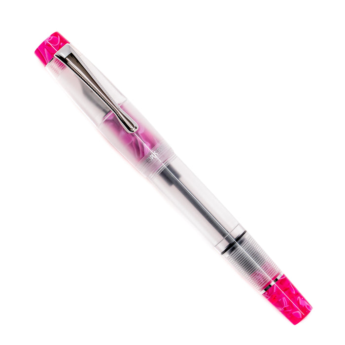 Opus 88 KOLORO hot pink fountain pen with transparent grip section and gold accents resting on a white background.