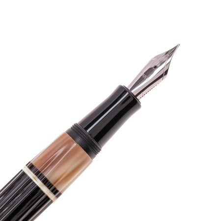 Opus 88 Buffalo horn fountain pen with gold nib, featuring a sleek design and transparent ink window, crafted by Opus88.