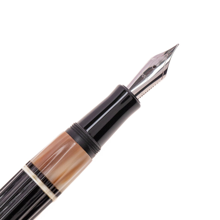 Opus 88 Buffalo horn fountain pen with gold nib, featuring a sleek design and transparent ink window, crafted by Opus88.