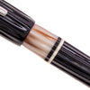 Opus 88 Buffalo Horn Fountain Pen with gold accents and transparent grip section, showcasing its elegant design and craftsmanship.