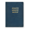 Medium Analog Memory Backup Journal by The Mincing Mockingbird with a kraft paper cover and black binding, open to blank lined pages.