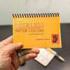 Peerless Watercolors Mini Complete Edition set with vibrant watercolor paints and brushes, perfect for artistic projects.