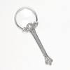 Small Le Potier D'etain magnifying glass with floral handle, featuring a clear glass lens and decorative flower design.