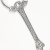Small magnifying glass with handle featuring a flower design, from Le Potier D'etain, close-up view showing detailed craftsmanship.