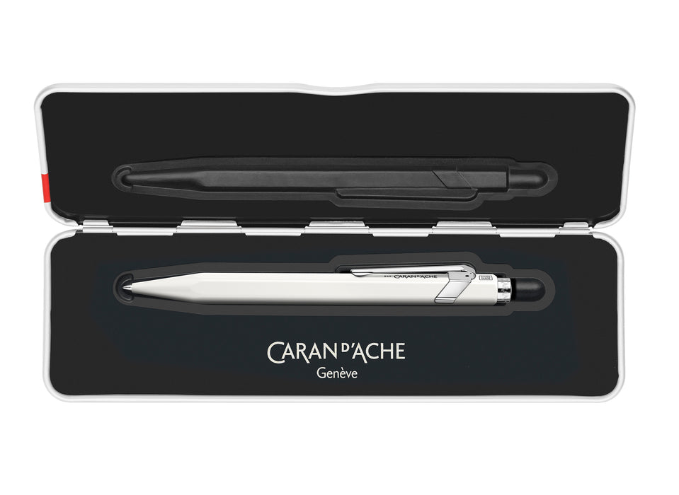 Caran D'Ache Roller Pen 849™ in white with sleek slim design, featuring a smooth rollerball tip and branded metal accents.