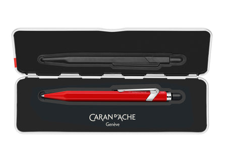 Caran D'Ache 849™ rollerball pen with a slim red barrel and metal accents, showcasing its sleek design and brand logo.