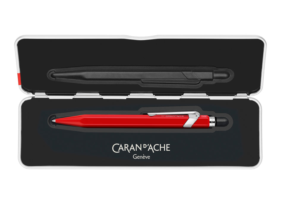 Caran D'Ache 849™ rollerball pen with a slim red barrel and metal accents, showcasing its sleek design and brand logo.