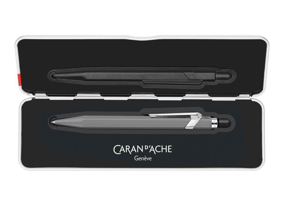 Caran D'Ache 849 rollerball pen with slim grey barrel, featuring a sleek and compact design for smooth writing.