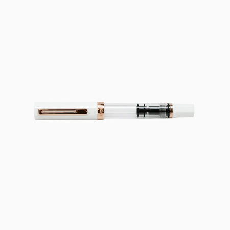 Twsbi Eco fountain pen in white with rose gold accents, featuring a sleek design and smooth ink flow.