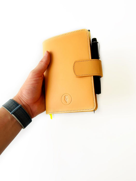 Aged natural leather A6 journal cover by Eng Leather Co. with visible stitching and smooth texture for a stylish notebook protection.