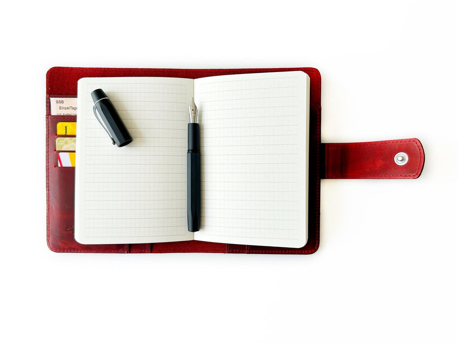 A6 leather journal cover in burgundy from Eng Leather Co., featuring a smooth, flat design with stitched edges.